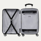 Open black hardside spinner suitcase showing interior with cross straps on one side and a zippered mesh divider pocket on the other.
