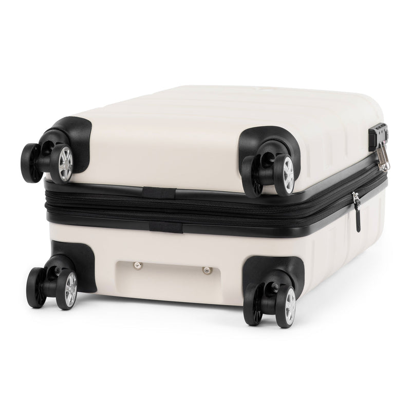 Bottom view of white hardside spinner with four 360° wheels and protective corner design.
