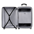Interior view of an open large hardshell spinner suitcase, showing two compartments one with adjustable cross straps and the other with a zippered mesh divider containing an additional zip pocket.