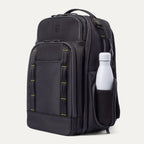 Three‑quarter front view of the Travelpro Altitude Large Backpack in Neon Shadow, showing black textured exterior with neon yellow stitching accents, multiple zippered compartments, and a white water bottle in the side pocket against a light background.