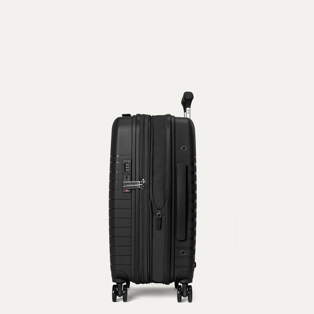 Black suitcase on a light gray background
