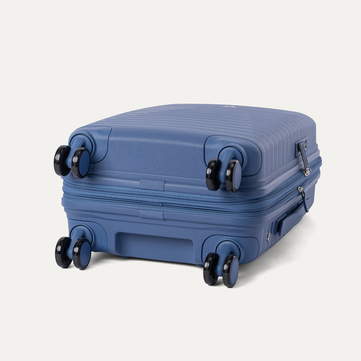 Blue suitcase with wheels on a light gray background