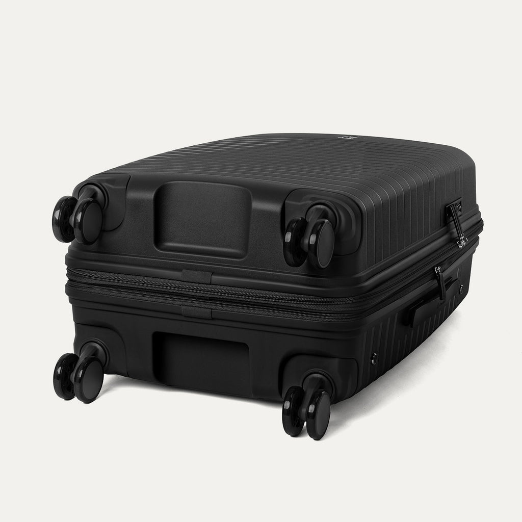 Black suitcase with wheels on a light gray background