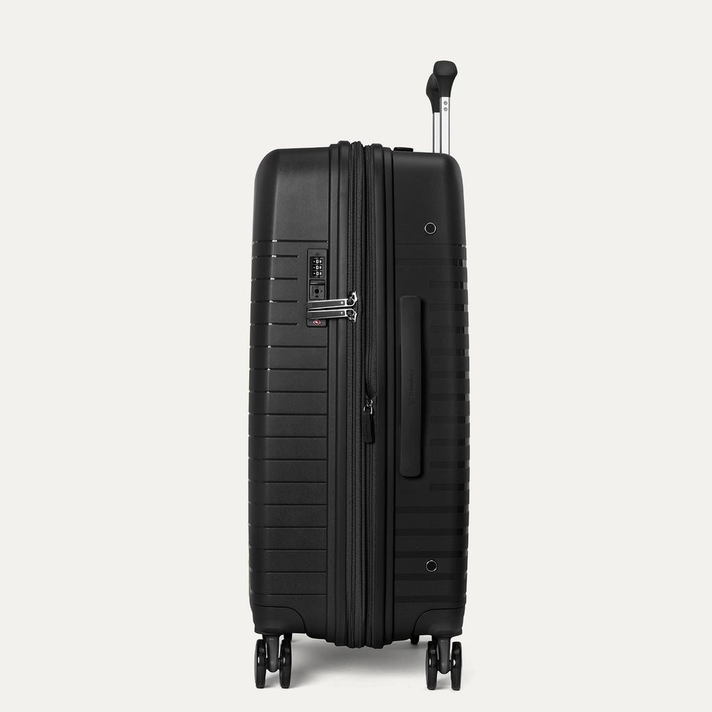 Black suitcase with wheels and handle on a light gray background