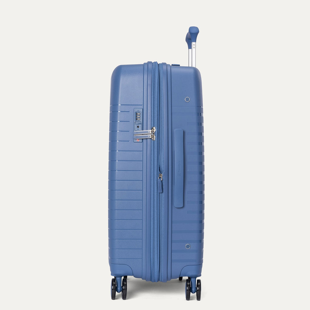 Blue suitcase with wheels and handle on a light gray background
