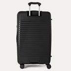 Black suitcase with a ribbed texture on a light gray background