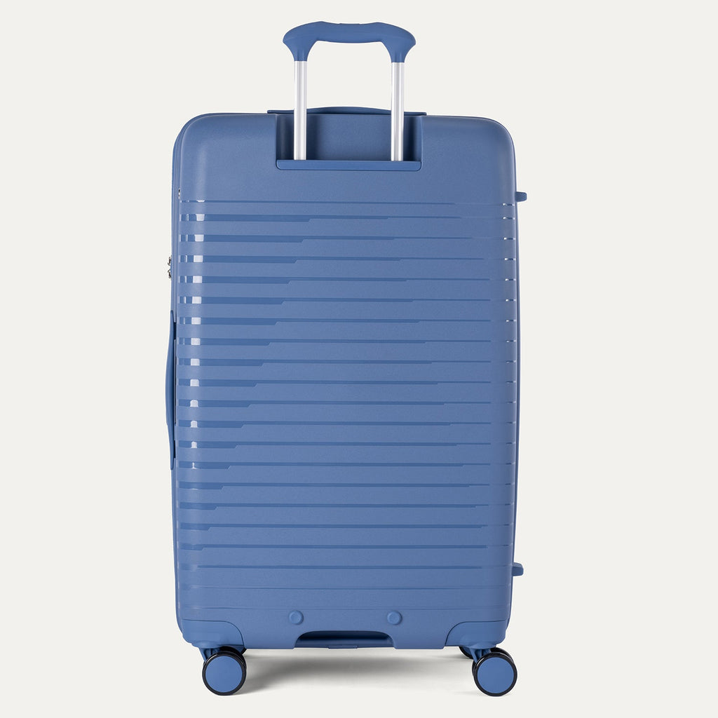 Blue suitcase with a textured surface on a light gray background