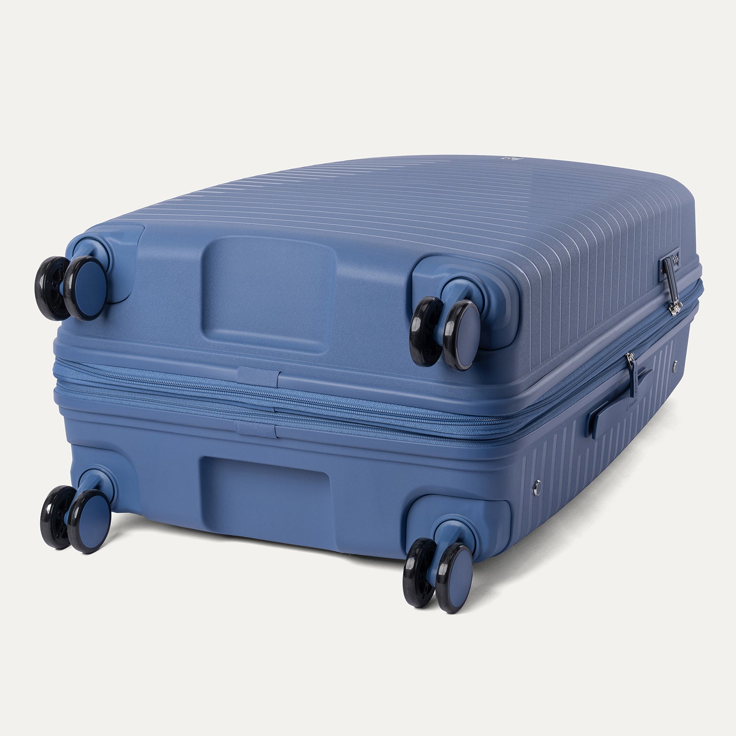 Blue suitcase with wheels on a light gray background