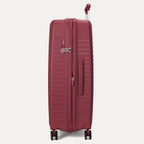 Maroon suitcase with wheels and handle on a light gray background
