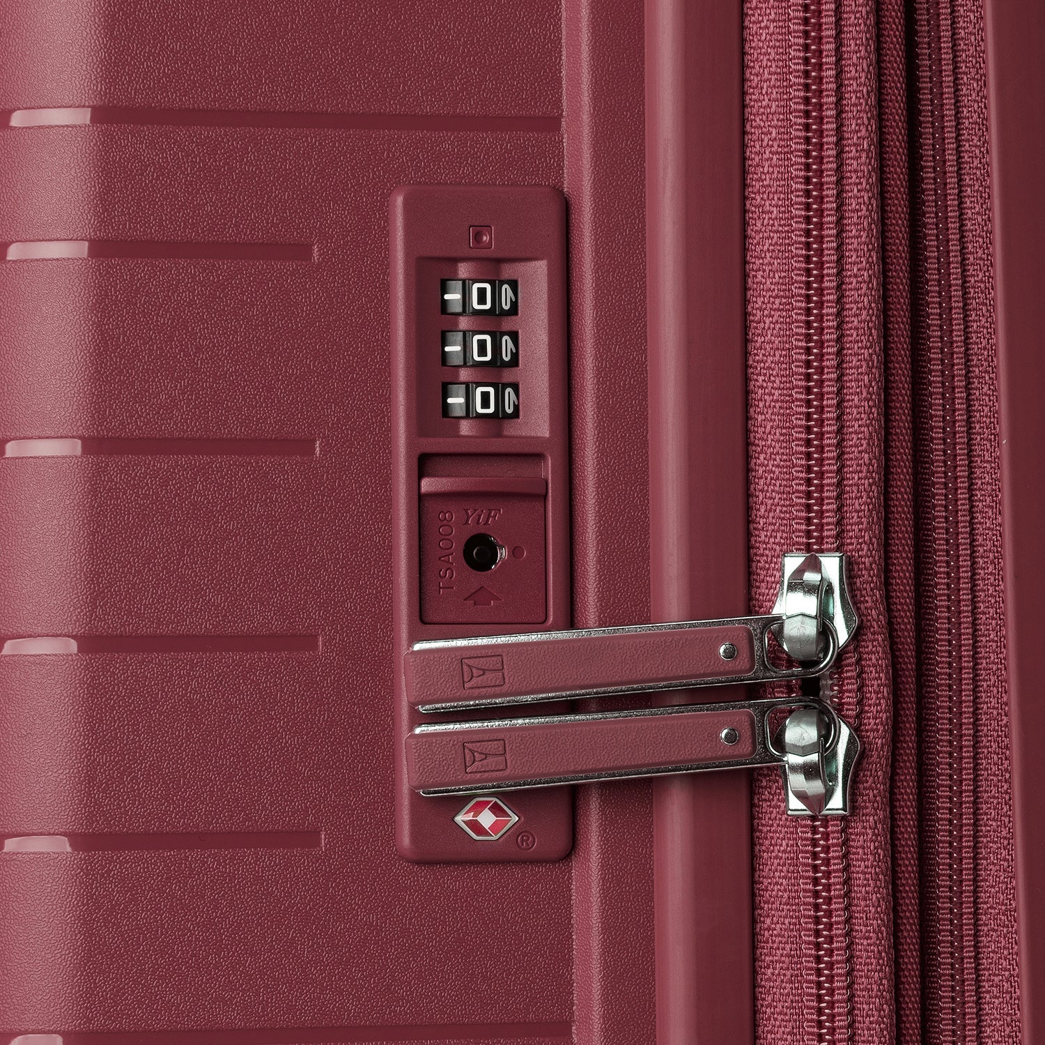 Close-up of a burgundy suitcase with a combination lock and zipper.