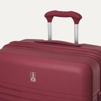 Maroon suitcase with handle on a white background