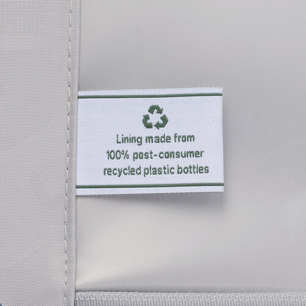 Label on a gray fabric product indicating 100% post-consumer recycled plastic bottles lining.
